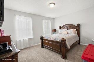 bedroom featuring light carpet and multiple windows