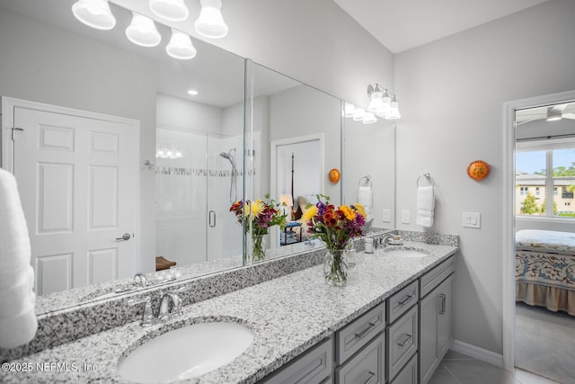 bathroom with tile patterned floors, vanity, and walk in shower