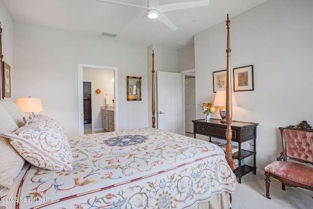 bedroom with ensuite bathroom, ceiling fan, and light colored carpet