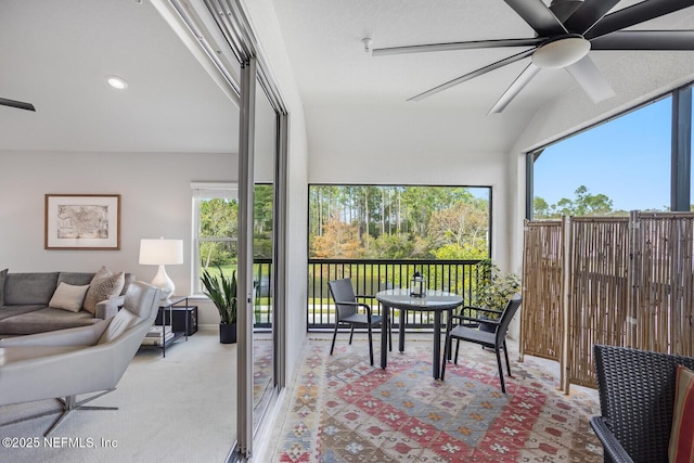 sunroom featuring ceiling fan and lofted ceiling