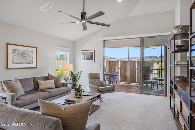 living room featuring carpet floors, ceiling fan, and lofted ceiling