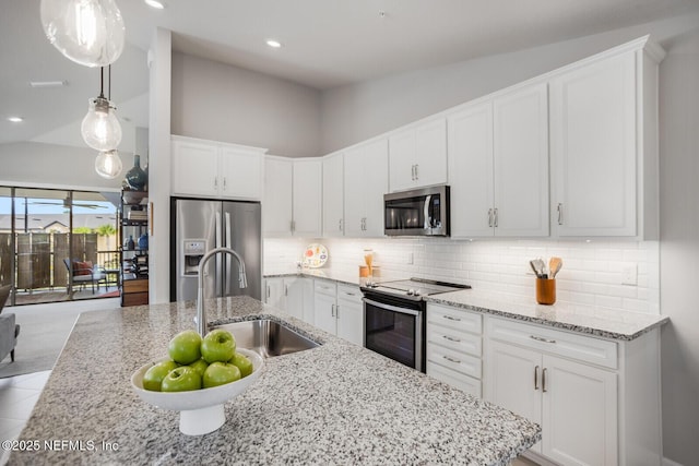 kitchen featuring backsplash, sink, lofted ceiling, and stainless steel appliances