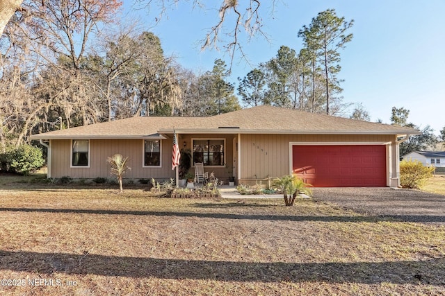 ranch-style house with a garage and covered porch