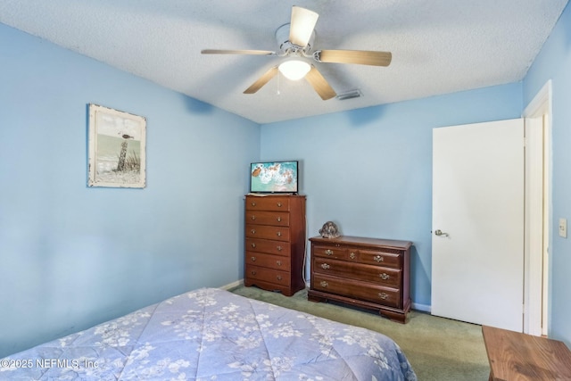 bedroom featuring light carpet, a textured ceiling, and ceiling fan