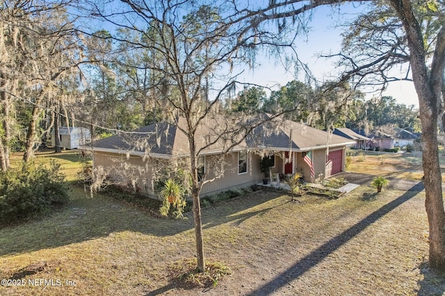 exterior space featuring a garage and a lawn