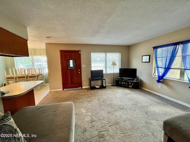 carpeted living room featuring a textured ceiling