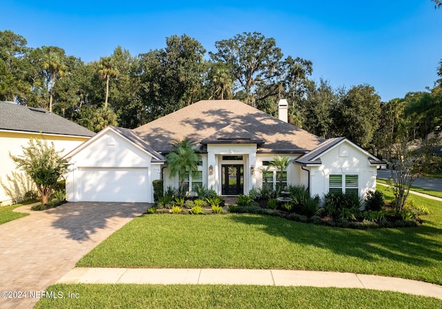 view of front facade featuring a front yard and a garage