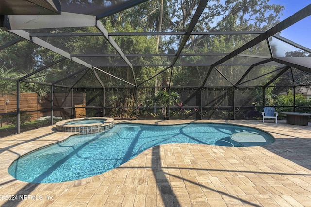 view of swimming pool featuring a patio area, an in ground hot tub, and glass enclosure