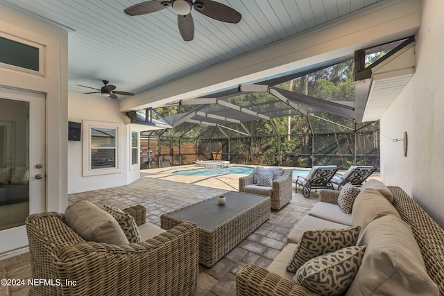 view of patio with a swimming pool with hot tub, an outdoor hangout area, ceiling fan, and a lanai