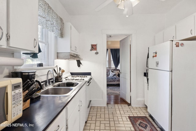 kitchen with white appliances, sink, ceiling fan, white cabinetry, and extractor fan