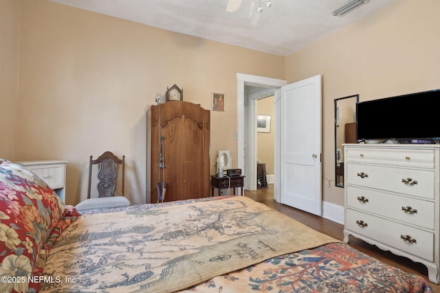 bedroom featuring ceiling fan and dark hardwood / wood-style floors