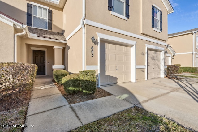 doorway to property with a garage