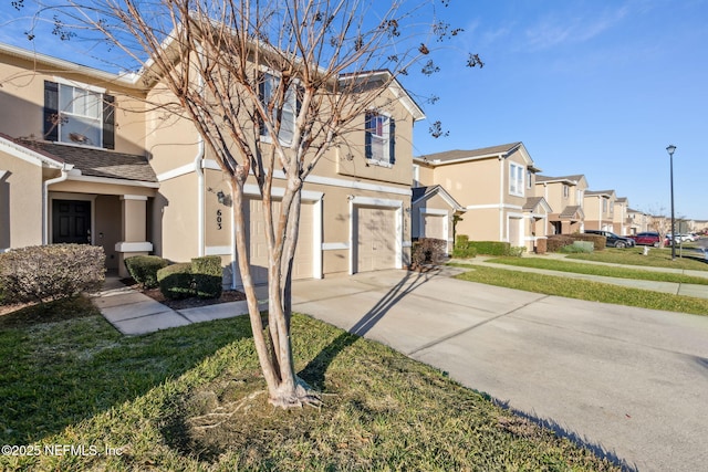 view of front of house featuring a garage and a front lawn