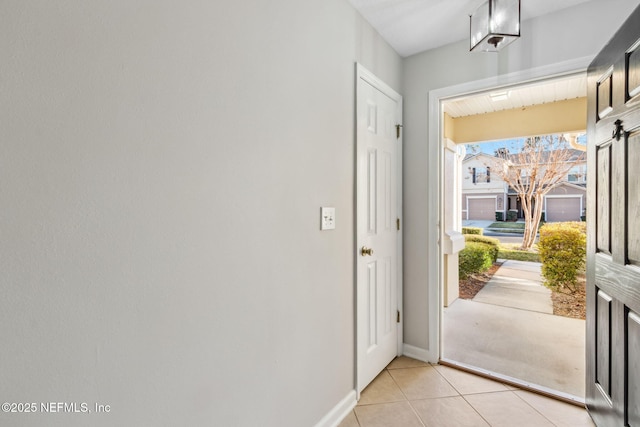 doorway with light tile patterned floors