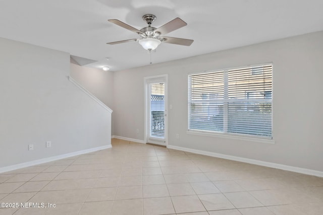 unfurnished room with light tile patterned flooring and ceiling fan