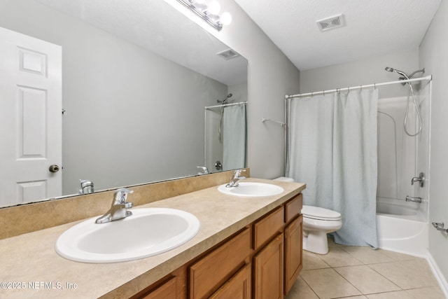 full bathroom featuring toilet, shower / tub combo, a textured ceiling, tile patterned floors, and vanity