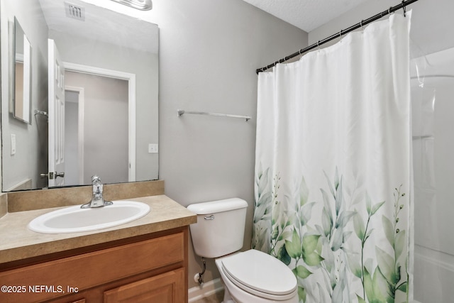 bathroom with toilet, vanity, and a shower with shower curtain