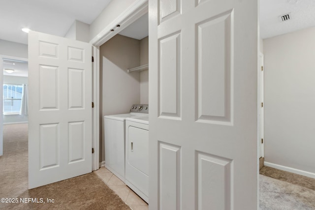 washroom with light tile patterned flooring and independent washer and dryer