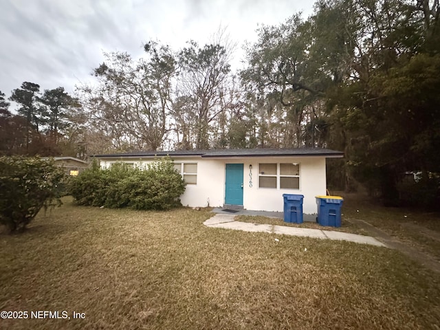 rear view of property with a lawn