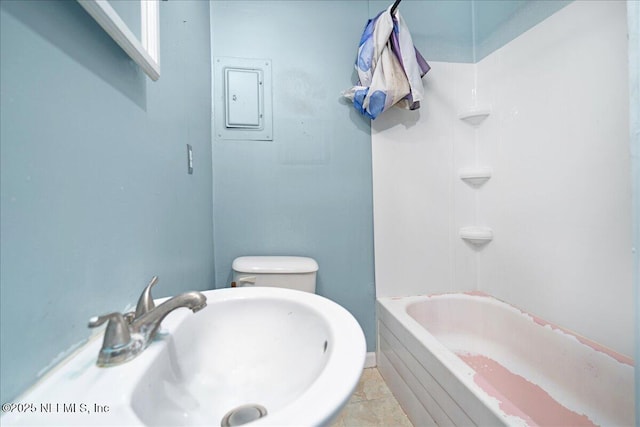 bathroom featuring tile patterned flooring, toilet, sink, and electric panel