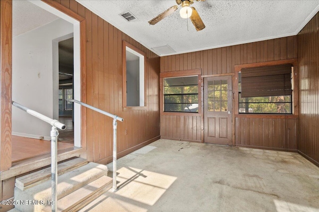 interior space with ceiling fan and a wealth of natural light