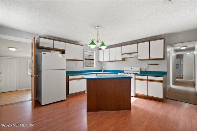 kitchen featuring pendant lighting, white appliances, light wood-type flooring, a kitchen island, and white cabinetry