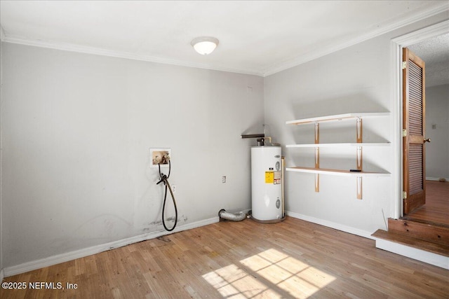 clothes washing area with wood-type flooring, crown molding, hookup for a washing machine, and water heater