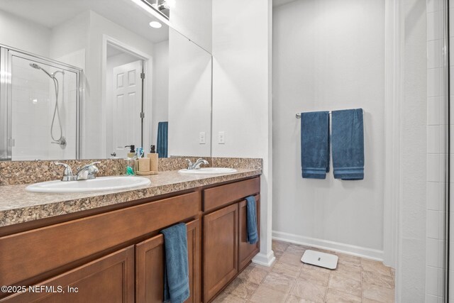 bathroom with vanity and a shower with shower door