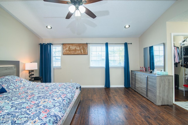 bedroom with multiple windows, vaulted ceiling, ceiling fan, and dark wood-type flooring