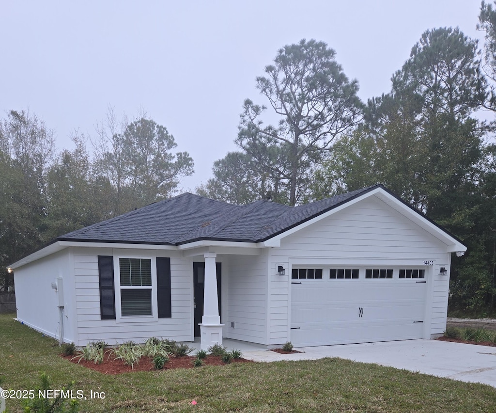 ranch-style home with a garage and a front yard