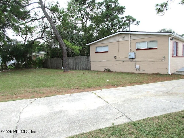 view of property exterior featuring a lawn