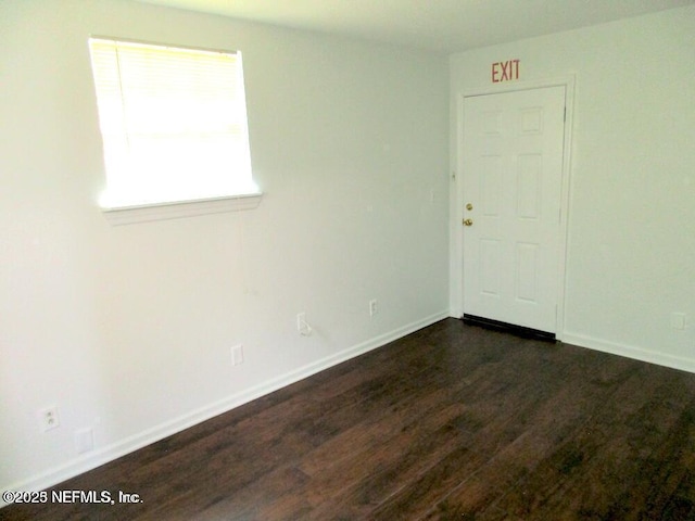 empty room featuring dark hardwood / wood-style flooring