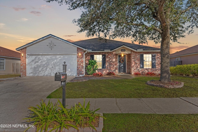 single story home featuring a lawn and a garage