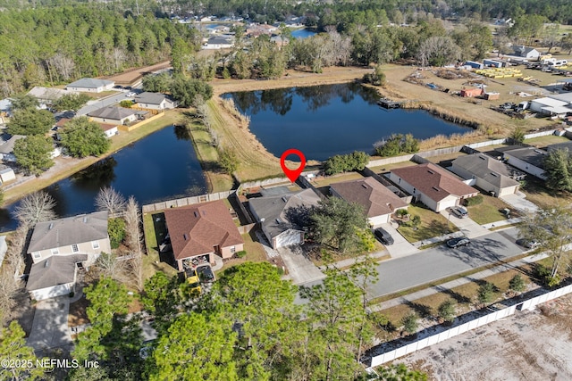 birds eye view of property with a water view