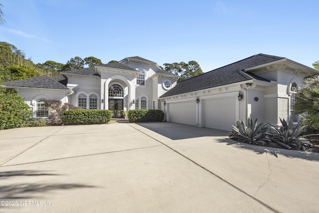 mediterranean / spanish home with a garage