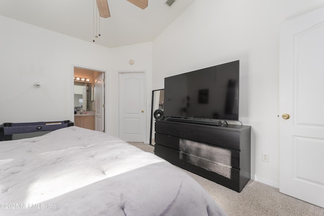 carpeted bedroom with ceiling fan, high vaulted ceiling, and ensuite bath