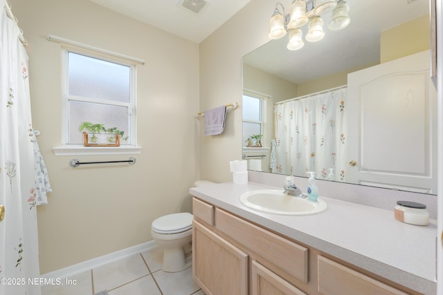 bathroom with toilet, vanity, a chandelier, and tile patterned flooring