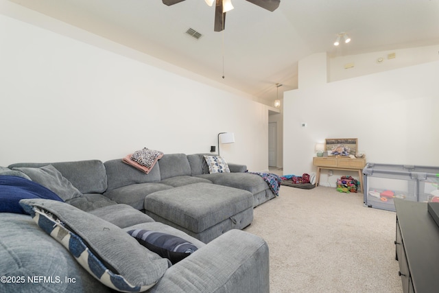 living room with vaulted ceiling, ceiling fan, and carpet