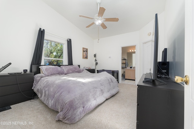 carpeted bedroom with ceiling fan, lofted ceiling, and ensuite bath