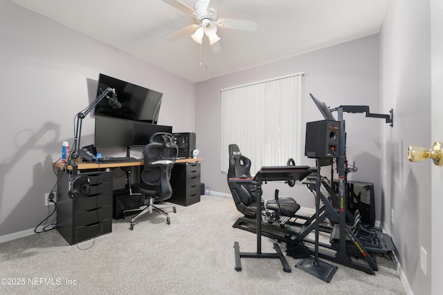 office area with ceiling fan, light colored carpet, and a textured ceiling