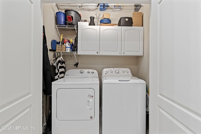 laundry room with washer and clothes dryer and cabinets