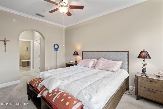 bedroom with ceiling fan, light colored carpet, ensuite bathroom, and crown molding