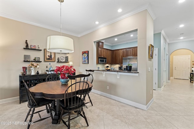 dining area featuring light tile patterned floors and ornamental molding