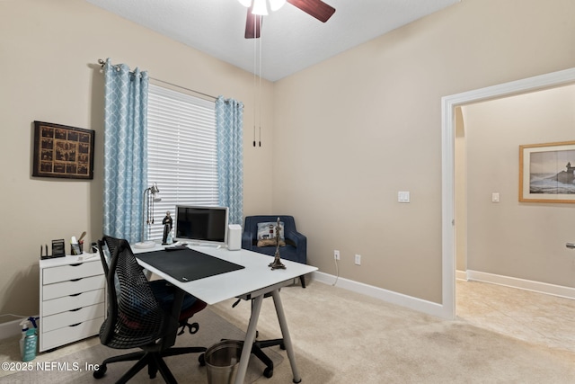 carpeted office space featuring ceiling fan