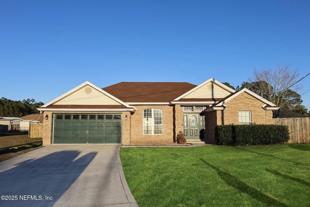 single story home with a front yard and a garage