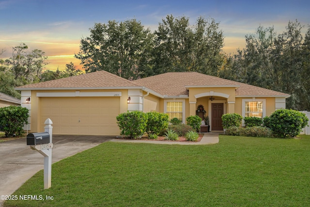 view of front facade featuring a garage and a lawn