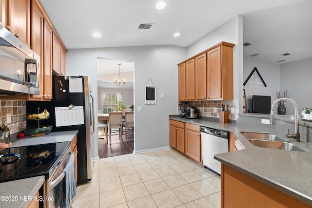 kitchen with light tile patterned flooring, sink, decorative backsplash, stainless steel appliances, and an inviting chandelier