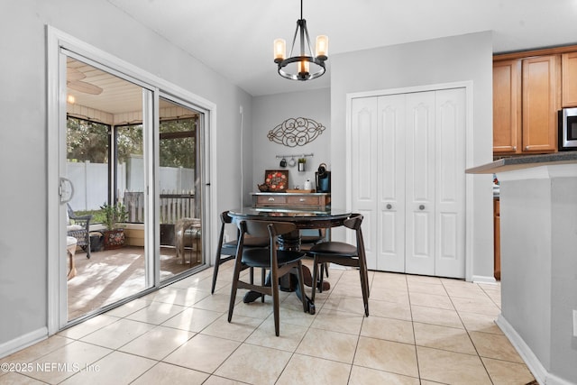 tiled dining area featuring a notable chandelier