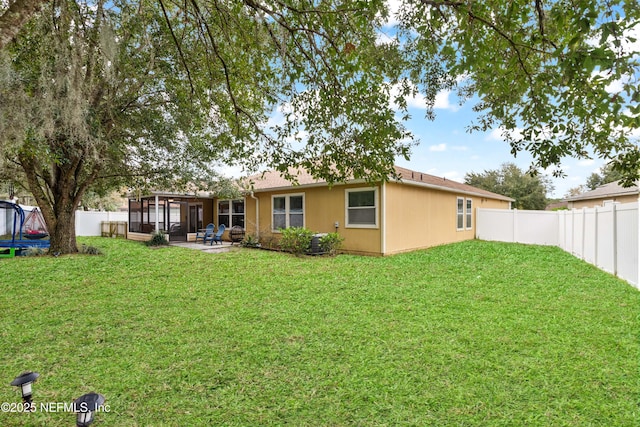 rear view of property with a yard and a patio