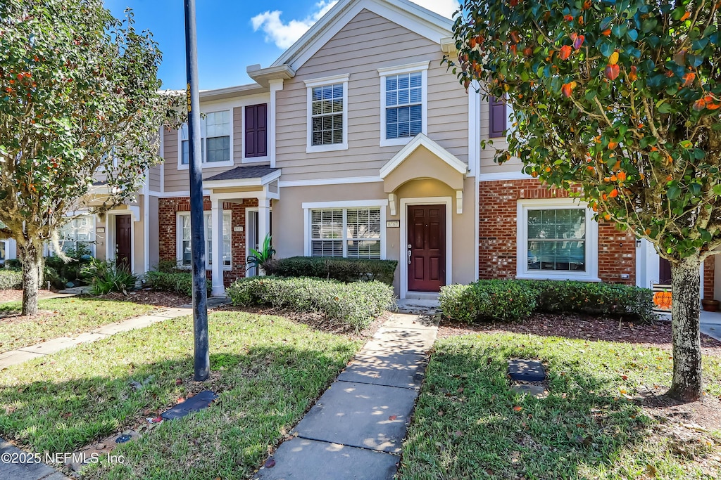 view of property featuring a front yard